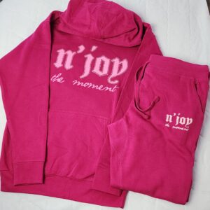 Pink hoodie and sweatpants set with white text.