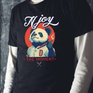 A person wearing a black t-shirt with a colorful clown graphic and text.