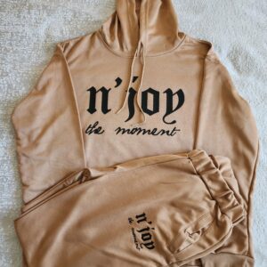 Beige hoodie and pants set with "n'joy the moment" text.